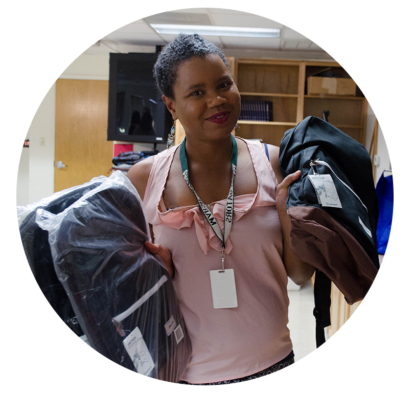 Image of Targeted Case Manager holding Backpacks